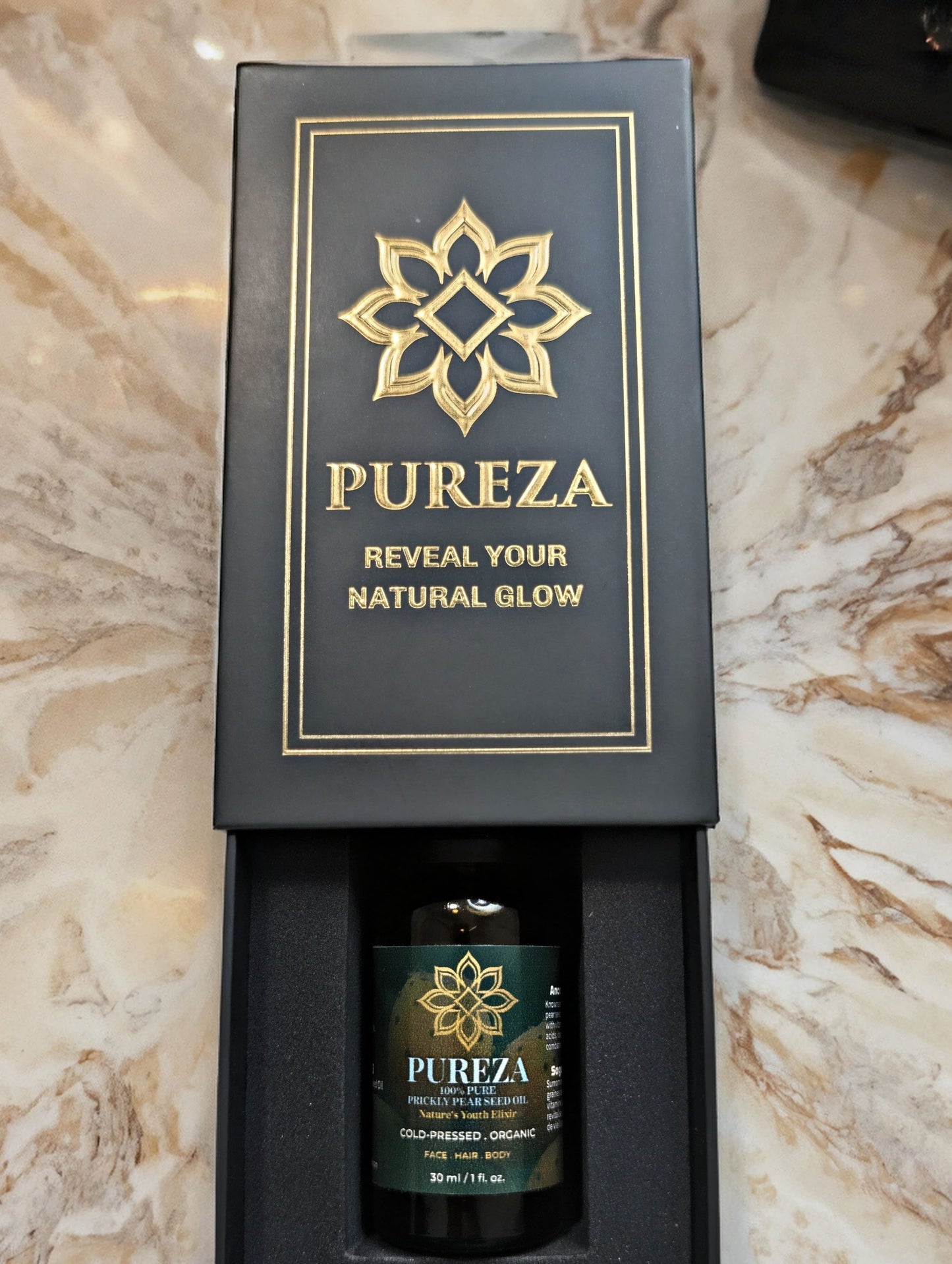 PUREZA Prickly Pear Seed oil packaging on a marble surface
