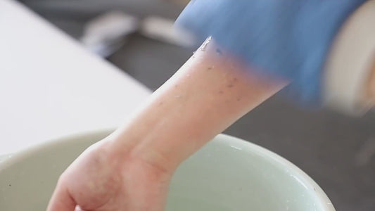Model using Pureza Kessa glove to exfoliate and remove dead skin